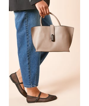 Spacious shopper tote design with ample room for daily essentials
        Versatile dual-carry option with top handles and detachable crossbody strap
        Sleek decorative clasp detail adds a contemporary touch
        Practical interior compartment with secure zip closure
        Durable faux leather finish that maintains its shape throughout the day
    
    The Bolton Shopper Tote from Dorothy Perkins combines practicality with understated style for the modern woman on the move. Perfect for casual outings, this versatile bag transitions effortlessly from morning coffee runs to afternoon shopping trips. Style with straight-leg jeans and a tailored blazer for brunch with friends, or pair with a floaty midi dress for family gatherings. The generous interior accommodates all your essentials whilst maintaining a polished silhouette. The convertible design allows you to carry it by the handles for a sophisticated look or attach the crossbody strap when you need hands-free convenience. This everyday staple works beautifully with both casual trainers and smart flats, making it an indispensable addition to your accessory collection for those busy days when functionality matters just as much as style.