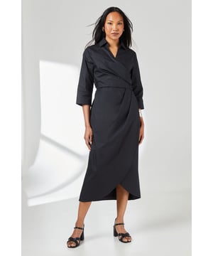 Elegant wrap design with asymmetric hemline for a contemporary silhouette
        Crisp collared neckline adds a refined touch to this versatile piece
        Three-quarter length sleeves offer practical coverage for transitional weather
        Cinched waist detail creates a flattering, feminine shape
        Cotton fabric provides breathable comfort for all-day wear
    
    This Principles wrap skirt collared shirt dress combines timeless sophistication with modern styling. The wrap design gracefully drapes across the body, creating an effortlessly chic look that works beautifully for various daytime occasions. Style with strappy sandals as seen on our model for casual weekend brunches, or pair with white trainers and a denim jacket for shopping trips with friends. The collared detail adds structure while the midi length offers versatility for family gatherings or informal work settings. For cooler days, layer with a lightweight cardigan and ankle boots. The cotton construction ensures comfort throughout the day, making this dress a practical yet stylish addition to your wardrobe that transitions seamlessly from casual coffee dates to relaxed dinner parties with minimal accessorising.