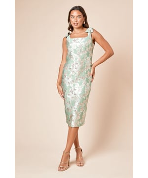 Elegant jacquard midi dress with eye-catching metallic floral pattern throughout
        Feminine bow shoulder straps add a charming, romantic touch
        Sophisticated square neckline frames the dcolletage beautifully
        Figure-flattering fitted silhouette with a midi length that hits mid-calf
        Subtle back vent allows for comfortable movement while maintaining the dress's sleek shape
    
    The DP Luxe Bow Shoulder Jacquard Midi Dress from Dorothy Perkins presents a refined option for your special occasion wardrobe. The textured jacquard fabric catches the light beautifully, whilst the delicate bow details on the shoulders add a feminine flourish to the sophisticated silhouette. Style with strappy metallic heels as seen on our model for an elegant ensemble perfect for weddings or formal gatherings. For cooler evenings, layer with a tailored blazer or a lightweight pashmina. Complete your look with statement earrings and a structured clutch bag to showcase the dress's exquisite detailing. This versatile piece transitions effortlessly from daytime celebrations like baby showers to evening events, making it a valuable addition to your occasion wear collection.