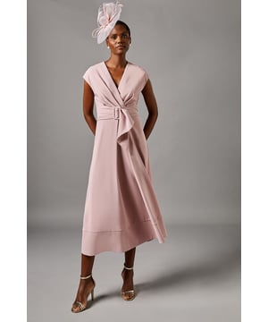 Elegant V-neckline for a flattering silhouette
        Wrap-style bodice with a cinched waist
        Striking belted detail with a rectangular buckle
        Cap sleeves for a graceful arm-flattering look
        Midi length with a flared A-line skirt
    
    This sophisticated belted crepe dress from Coast is the epitome of refined elegance. Perfect for those special occasions where you want to make a lasting impression, this dress combines timeless style with modern flair. The wrap-style bodice creates a flattering silhouette, while the belted waist accentuates your figure beautifully. The midi length and flared skirt offer a graceful movement as you walk, ideal for garden parties or summer weddings. Style it with strappy heels and delicate jewellery for a polished look, or add a fascinator for a day at the races. For cooler evenings, drape a lightweight pashmina over your shoulders to maintain that air of sophistication. This versatile piece will become a go-to in your occasion wear wardrobe, promising to turn heads at any event.