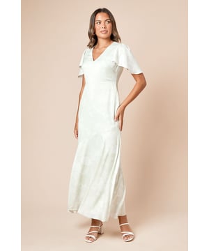 Elegant V-neckline complemented by delicate angel sleeves for a feminine silhouette
        Flattering midi length with a subtle flared hem that creates graceful movement
        Soft woven fabric adorned with a subtle floral pattern throughout
        Fully lined for comfort and a smooth drape against the skin
        Figure-enhancing cut that gently skims the body's natural contours
    
    The DP Luxe Angel Sleeve Midi Dress from Dorothy Perkins offers sophisticated charm for your special occasions. The graceful angel sleeves add a touch of whimsy whilst maintaining an elegant profile, perfect for those who prefer modest yet stylish coverage. The V-neckline frames the dcolletage beautifully without revealing too much, whilst the midi length ensures versatility for various formal settings. Style with strappy heeled sandals as shown and delicate drop earrings for wedding receptions or graduation ceremonies. For race day events, pair with a coordinating fascinator and clutch bag. The dress transitions seamlessly from daytime celebrations to evening gatherings-simply switch your accessories to match the occasion's formality. This piece strikes the perfect balance between contemporary design and timeless appeal, making it a wardrobe staple for the woman who appreciates refined elegance.