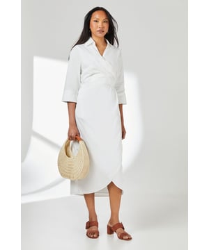Elegant wrap design with asymmetric hemline for a contemporary silhouette
        Crisp collared neckline adds a refined touch to this versatile piece
        Three-quarter length sleeves offer practical coverage for transitional weather
        Cinched waist detail creates a flattering, feminine shape
        Cotton fabric provides breathable comfort for all-day wear
    
    This Principles wrap skirt collared shirt dress combines timeless sophistication with modern styling. The wrap design gracefully drapes across the body, creating an effortlessly chic look that works beautifully for various daytime occasions. Style with strappy sandals as seen on our model for casual weekend brunches, or pair with white trainers and a denim jacket for shopping trips with friends. The collared detail adds structure while the midi length offers versatility for family gatherings or informal work settings. For cooler days, layer with a lightweight cardigan and ankle boots. The cotton construction ensures comfort throughout the day, making this dress a practical yet stylish addition to your wardrobe that transitions seamlessly from casual coffee dates to relaxed dinner parties with minimal accessorising.