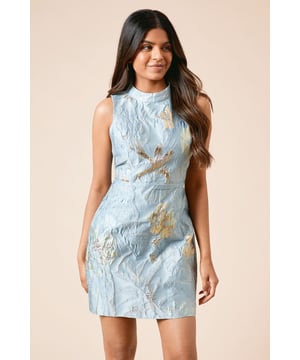 Elegant jacquard fabric with metallic floral detailing for a sophisticated finish
        Flattering halterneck design with a high neckline for refined coverage
        Sleeveless silhouette perfect for showcasing jewellery and accessories
        Mini length cut in a figure-enhancing petite fit
        Back keyhole detail with button fastening for a polished look
    
    This Dorothy Perkins Petite Jacquard Halterneck Mini Dress combines timeless elegance with contemporary style. The textured jacquard fabric with its subtle metallic pattern creates visual interest whilst maintaining sophistication. Designed specifically for petite frames, this dress offers the perfect proportions without overwhelming your silhouette. Style with strappy heeled sandals as shown for formal occasions such as weddings or graduation ceremonies. For a refined daytime look suitable for baby showers or brunch with friends, pair with a cropped blazer and court shoes. The versatile design transitions beautifully from day to evening events with simple accessory changes - opt for delicate drop earrings and a clutch bag to complete your ensemble. The halterneck design flatters the dcolletage whilst the structured fabric ensures the dress maintains its shape throughout wear.