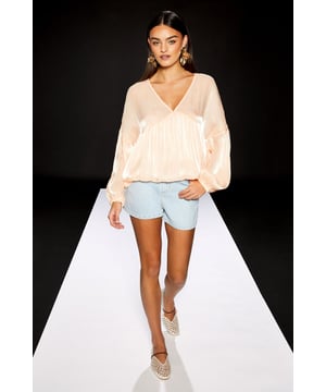 Striking blouson sleeves create a dramatic silhouette with voluminous proportions
        Elegant V-neckline frames the dcolletage for a feminine touch
        Sheer organza fabric offers a delicate, lightweight feel with subtle lustre
        Oversized fit provides effortless comfort and contemporary styling
        Part of the exclusive RUNWAY 1.8.1.8 collection from Warehouse
    
    Make a statement with this ethereal blouson sleeve blouse from Warehouse's RUNWAY 1.8.1.8 collection. The diaphanous organza fabric creates a gossamer-like appearance that catches the light beautifully, whilst the relaxed silhouette offers versatile styling options. As seen on our model, pair with denim shorts and statement earrings for a casual daytime look that balances the blouse's dramatic proportions. The oversized fit works brilliantly with slim-fitting bottoms - try with tailored cigarette trousers and flat mules for lunch with friends, or tucked into high-waisted jeans for weekend brunches. The V-neckline allows for layered necklaces to add personal flair. This piece transitions seamlessly from day to evening - simply swap your trainers for a block heel and you're ready for dinner or drinks.
