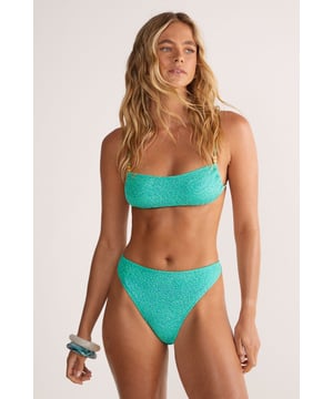 Textured glitter fabric that catches the light beautifully for a standout beach look
        Square neckline top with elegant beaded strappy detail for added sophistication
        Tie-back fastening allows for adjustable fit and support
        High-leg bikini bottoms create a flattering silhouette
        Gold-toned bead accents on straps add a touch of luxe detailing
    
    Make a statement poolside in this eye-catching Nasty Gal bikini set. The textured glitter fabric creates a dazzling effect that shimmers in the sunlight, whilst the square neckline offers a contemporary twist on classic swimwear. The beaded strappy detail adds a touch of glamour that transitions effortlessly from daytime swimming to sunset beach parties. Style with oversized sunglasses and stacked bangles, as shown on our model, for a complete resort-ready ensemble. Perfect for your next holiday getaway, this two-piece set works brilliantly for lounging by the pool or strolling along the shoreline. For a complete beach day look, pair with a sheer cover-up and strappy sandals, adding a wide-brimmed hat for both style and sun protection. This versatile bikini set ensures you'll stand out for all the right reasons on your summer adventures.