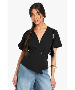 Flattering wrap-style design with elegant V-neckline
        Stylish short flutter sleeves for a feminine touch
        Decorative button detail adds subtle sophistication
        Cropped length perfect for high-waisted bottoms
        Stretch fabric ensures comfortable all-day wear
    
    This versatile crop top combines chic styling with practical comfort for effortless occasion dressing. The wrap-front design creates a flattering silhouette whilst the flutter sleeves add a touch of softness to your look. Style with tailored high-waisted trousers and strappy heels for formal events, or pair with wide-leg jeans as shown for a contemporary smart-casual ensemble. The V-neckline provides the perfect canvas for statement jewellery - try layered necklaces for evening affairs or keep minimal for daytime sophistication. The stretch fabric moves with you throughout the day, making this top ideal for everything from graduation ceremonies to summer weddings. Complete your outfit with a structured clutch and sleek updo for a polished finish that transitions seamlessly from day to night.