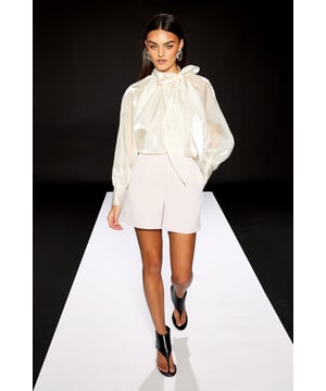 High-waisted design with clean, tailored silhouette for a sophisticated profile
        Crafted from lightweight crepe fabric offering elegant drape and structure
        Subtle side pockets provide practical functionality without disrupting the sleek lines
        Part of the exclusive RUNWAY 1.8.1.8 City Style collection from Warehouse
        Versatile smart shorts perfect for formal occasions with a contemporary twist
    
    These impeccably tailored Warehouse shorts from the RUNWAY 1.8.1.8 collection present a refined alternative to traditional occasion wear. The clean lines and structured silhouette create a polished look that commands attention at formal events. Style with a dramatic bow blouse as shown for a striking contrast of textures, or pair with a fitted blazer for a modern suit effect. The high-waisted design flatters the figure whilst the modest length ensures appropriateness for weddings, races or graduation ceremonies. Complete the ensemble with statement heels and minimal jewellery to maintain the contemporary aesthetic. These shorts transition beautifully from daytime formality to evening sophistication, making them a versatile investment piece for your occasion wardrobe. Their tailored precision reflects the confident, feminine ethos that defines the Warehouse brand.
