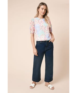 Delicate mesh overlay with charming floral pattern throughout
        Elegant gathered neckline adds subtle feminine detail
        Romantic puff sleeves with gentle elasticated cuffs
        Regular fit silhouette offers comfortable everyday wear
        Versatile crew neckline suitable for layering with necklaces
    
    This enchanting mesh top from Dorothy Perkins combines comfort with effortless style. The gathered neckline creates a flattering shape whilst the puff sleeves add a touch of romance to your everyday wardrobe. Style with wide-leg denim trousers as shown for a relaxed brunch date, or pair with a tailored skirt for family gatherings. The lightweight construction makes it perfect for layering under cardigans when the temperature drops. For casual outings, complement with white trainers and a crossbody bag, or dress it up slightly with ballet flats and delicate jewellery for baby showers. The versatile design works beautifully for daytime events whilst maintaining that put-together look Dorothy Perkins customers adore - stylish without showing too much skin.