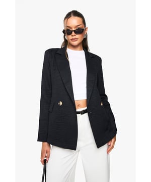 Oversized blazer with a relaxed silhouette for effortless layering
        Double-breasted design with decorative metallic buttons for a polished finish
        Structured collar and lapels adding a sophisticated touch
        Practical front pockets perfect for small essentials
        Linen-look texture providing visual interest and dimension
    
    Make a statement with this versatile oversized blazer from Boohoo. The relaxed fit offers both comfort and contemporary style, whilst the double-breasted design adds a touch of classic tailoring. Perfect for casual occasions, pair with matching wide-leg trousers as shown for a coordinated look that works brilliantly for family gatherings or brunch dates. For daytime chic, style with your favourite denim and trainers, or dress up with a slip dress and heeled sandals for evening drinks. The structured silhouette creates a flattering shape despite its generous proportions, making it an ideal layering piece for transitional weather. This blazer effortlessly bridges the gap between smart and casual, ensuring you'll reach for it time and again throughout the seasons.