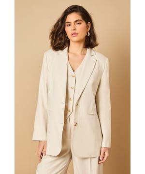 Oversized silhouette with relaxed shoulders for a contemporary, fashion-forward look
        Notched lapels and structured tailoring create a refined, elegant appearance
        Front button fastening with coordinating buttons for a cohesive finish
        Functional front pockets perfect for adding practicality to your formal ensemble
        Linen-look fabric offers a lightweight feel ideal for warmer weather occasions
    
    Make a statement with this beautifully crafted oversized blazer from Oasis. The relaxed fit creates a modern silhouette whilst maintaining a sophisticated edge that works brilliantly for both formal and casual settings. Style as seen with the matching wide-leg trousers for a coordinated suit that commands attention at summer weddings or garden parties. For everyday elegance, pair with slim-fit trousers and a simple camisole, finishing with delicate jewellery as shown on our model. The versatile nature of this blazer makes it perfect for layering during transitional seasons - wear open over a fitted dress for race day events or buttoned up with tailored shorts for a contemporary twist on occasion dressing. The clean lines and feminine cut embody Oasis' signature style whilst offering endless styling possibilities.