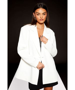 Part of the exclusive RUNWAY 1.8.1.8 collection, this single-breasted blazer showcases contemporary design with a boxy silhouette
        Crafted from lightweight crepe fabric that offers a structured yet comfortable feel
        Features a classic collared neckline and clean-lined lapels for a sophisticated finish
        Single button fastening creates a flattering shape while maintaining the modern, relaxed fit
        Versatile design that works seamlessly from office to evening occasions
    
    This Warehouse RUNWAY 1.8.1.8 blazer redefines casual sophistication with its contemporary boxy fit. The clean lines and minimalist design make it an essential wardrobe staple that transitions effortlessly between settings. Style as seen on our model with a sequined or metallic top and shorts for a striking contrast that balances the blazer's structured silhouette. For daywear, pair with straight-leg trousers and trainers for an effortlessly chic look perfect for lunch dates or gallery visits. Alternatively, throw over a simple t-shirt dress with ankle boots for weekend brunches. The versatility of this piece allows for countless styling options while the collared detail adds a touch of refinement to even the most casual ensembles. This blazer embodies the confident, edgy aesthetic that Warehouse is known for, making it an investment piece for the fashion-forward woman.