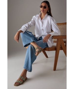 Striking faux patent leather finish that catches the light beautifully
        Distinctive double strap design with eye-catching eyelet and buckle detailing
        Comfortable flat heel measuring between 0-2cm for all-day wearability
        Cushioned footbed providing essential support for extended wear
        Durable synthetic outsole offering reliable grip on various surfaces
    
    These Faith sliders showcase contemporary British style with their statement eyelet and buckle detailing. The gleaming faux patent finish adds a touch of sophistication to even the most casual ensembles. Perfect for warm-weather outings, these versatile flats pair brilliantly with everything from tailored shorts and a ruffled camisole to floaty summer dresses. The practical flat design ensures comfort during family gatherings, weekend brunches, or seaside strolls. Their slip-on style makes them an effortless choice for garden parties or casual shopping trips, while the distinctive hardware elements present a fashion-forward edge that elevates your everyday wardrobe. These sliders transition seamlessly from daytime casual to relaxed evening occasions, making them an essential addition to your summer footwear collection.