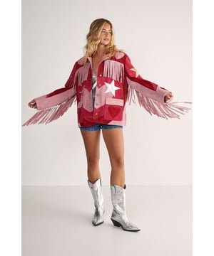 Genuine suede jacket featuring dramatic fringe detailing across the shoulders and sleeves
        Statement star pattern design for a bold, eye-catching look
        Button-through front closure with classic collar
        Practical patch pockets at the front
        Relaxed silhouette for comfortable layering
    
    Make a striking entrance in this show-stopping Real Suede Heart Fringe Jacket from Nasty Gal. The dramatic fringe detailing creates movement with every step, whilst the bold star pattern commands attention wherever you go. Perfect for those nights when ordinary simply won't do, this jacket pairs brilliantly with denim shorts and metallic boots as shown, or style with skinny jeans and a simple camisole to let the jacket take centre stage. The genuine suede construction offers a luxurious feel that will develop character over time. Whether you're heading to a gig, meeting friends at a trendy bar, or dancing the night away, this distinctive piece will ensure you stand out from the crowd. The relaxed fit allows for easy layering over both casual and dressier ensembles, making it a versatile addition to your going-out wardrobe.