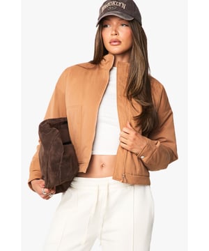 Distinctive funnel collar design for added warmth and contemporary style
        Cropped silhouette perfect for highlighting high-waisted bottoms
        Ribbed cuffs and hem for a snug, comfortable fit
        Front zip fastening for easy wear and versatile styling options
        Practical side pockets for everyday functionality
    
    This bomber jacket combines classic athletic appeal with modern design elements, making it a versatile addition to your casual wardrobe. The distinctive funnel collar adds a contemporary twist while providing extra protection against the elements. Style with wide-leg trousers and a crop top as shown for an effortlessly cool daytime look, or pair with slim-fit jeans and trainers for weekend coffee runs. The cropped length works brilliantly with high-waisted bottoms, creating a balanced silhouette. Perfect for family gatherings, casual brunches or shopping trips with friends, this Boohoo bomber can be layered over hoodies during cooler months or worn with lightweight tops when the temperature rises. Accessorise with a baseball cap and minimal jewellery for an understated finish that maintains the jacket's relaxed yet fashion-forward appeal.