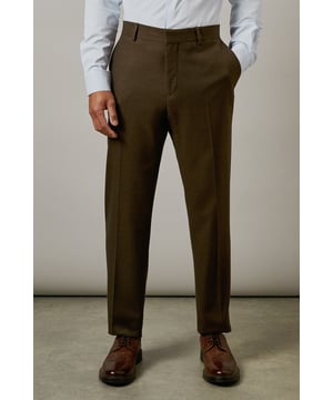 Tailored fit design offering a refined silhouette that defines your shape whilst maintaining comfort
        Tweed-look texture adds distinctive character and visual interest to these formal trousers
        Clean front styling with belt loops for versatile wearing options
        Back welt pockets with button closure for secure storage
        Straight leg cut with a clean finish that sits perfectly atop formal footwear
    
    These sophisticated tweed-look trousers deliver classic British style with contemporary tailoring. The tailored fit sculpts your silhouette whilst allowing ease of movement-perfect for the gentleman who appreciates traditional aesthetics with modern comfort. Style them as shown with a crisp white shirt and matching suit jacket for formal occasions, or dress them down with a quality knit jumper for smart-casual gatherings at the pub. The versatile khaki hue works brilliantly across seasons, making these trousers a wardrobe cornerstone. For business meetings, pair with polished brogues and a coordinating tie; for weekend socials, consider relaxing the look with a quality Oxford shirt, no tie. These Burton trousers bridge the gap between classic formality and everyday sophistication-ideal for the man who values timeless style over fleeting trends.