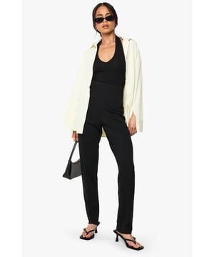 Sleek slim-fit design crafted from ponte fabric for exceptional shape retention
        Streamlined silhouette with clean front seam detailing for a polished look
        Comfortable stretch blend that moves with your body throughout the day
        Versatile mid-rise waistband offering flattering support
        Classic straight-leg cut that pairs effortlessly with both casual and smart attire
    
    These Boohoo slim-fit trousers are the wardrobe essential you've been searching for. The ponte fabric creates a smooth, structured silhouette while maintaining remarkable comfort for all-day wear. Style them as shown with a simple black top and strappy heels for evening drinks, or dress them down with trainers and an oversized blazer for daytime chic. The versatile design transitions seamlessly from office to weekend brunch, making them ideal for the fashion-forward woman who values both style and practicality. For casual gatherings, pair with a relaxed tee and denim jacket, or elevate your look with a silky blouse and statement jewellery for family celebrations. These trousers offer the perfect balance of comfort and sophistication, ensuring they'll quickly become your go-to piece for countless occasions.