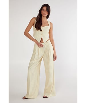 Tailored wide-leg trousers with classic pinstripe pattern
        High-waisted design for a flattering silhouette
        Practical side pockets for everyday essentials
        Wide-leg cut offering comfortable movement
        Versatile design suitable for both professional and casual settings
    
    These Nasty Gal Butter Pinstripe Tailored Trousers bring sophisticated workwear to new heights. The high-waisted design creates a lengthening effect whilst the wide-leg silhouette offers both comfort and contemporary style. Pair with the matching crop top as shown for a coordinated two-piece ensemble that commands attention in the office, or style with a crisp white shirt and blazer for more formal workplace settings. For after-hours events, swap office footwear for strappy heels and add statement jewellery. The versatile pinstripe pattern honours traditional tailoring whilst the modern cut ensures these trousers transition seamlessly from boardroom presentations to evening drinks. The side pockets add practicality to this stylish piece, making these trousers an essential addition to your professional wardrobe.
