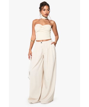 Dramatic extreme wide-leg design creates a flowing, statement silhouette
        High-waisted fit with button fastening for a secure and flattering shape
        Side pockets add practical functionality to this fashion-forward piece
        Soft fabric with slight stretch ensures comfort throughout the day
        Versatile trousers that can be styled for multiple occasions with ease
    
    Make a bold fashion statement with these eye-catching extreme wide-leg trousers from Boohoo. The dramatic flowing silhouette creates movement with every step whilst the high-waisted design accentuates your natural waistline for a flattering look. As seen on our model, pair with a coordinating bandeau top for a chic co-ord effect that's perfect for summer socials. For casual daytime wear, style with a fitted tee and trainers, or dress up with a bodysuit and heels for evening drinks. The neutral tone makes these trousers incredibly versatile for mixing and matching with your existing wardrobe favourites. The addition of practical side pockets enhances the wearability of this standout piece, making it as functional as it is fashionable for family gatherings and casual outings alike.