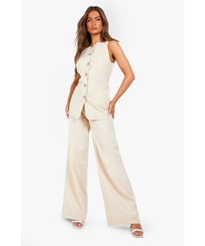 Textured woven fabric with distinctive structured finish for added visual interest
        High-waisted design with elegant button fastening for a flattering silhouette
        Straight leg cut with full-length wide profile for contemporary styling
        Clean, minimalist design perfect for versatile wardrobe integration
        Comfortable fit with generous leg room for all-day wearability
    
    These structured straight-leg trousers from Boohoo offer the perfect balance of comfort and contemporary style. The textured fabric adds subtle dimension to your look while the high-waisted design creates a flattering shape that works brilliantly with both fitted and oversized tops. Style them as shown with a simple white t-shirt for casual daytime outings, or dress them up with a fitted blouse and blazer for more polished occasions. The generous wide-leg silhouette provides excellent movement while maintaining a clean line from hip to hem. These trousers work beautifully with trainers for a relaxed weekend look or pair them with loafers for family gatherings. Their versatility makes them an essential wardrobe staple that transitions effortlessly from casual coffee dates to smart-casual office environments with just a simple change of accessories.
