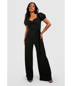 Sweetheart neckline for a feminine touch
        Puff sleeves add a romantic flair
        Tie waist detail for a customisable fit
        Wide leg silhouette for a dramatic look
        Scuba crepe fabric offers structure and comfort
    
    Make a statement in this eye-catching wide leg jumpsuit, perfect for those nights out when you want to turn heads. The puff sleeves and sweetheart neckline create a romantic silhouette, while the tie waist allows you to accentuate your figure. The wide leg design adds drama and movement, ideal for dancing the night away. Style it with strappy heels and a clutch bag for a chic club ensemble, or dress it down with trainers and a denim jacket for a more casual drinks outing. The versatile nature of this jumpsuit makes it a go-to piece for various social occasions, from bar hopping with friends to a night of urban exploration. Its blend of comfort and style ensures you'll feel confident and fashionable throughout your evening adventures.