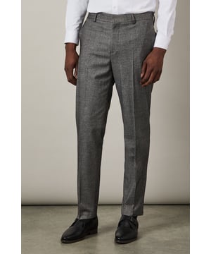 Distinctive herringbone pattern adds subtle texture and visual interest
        Slim fit design offers a contemporary silhouette that flatters the modern man
        Flat front styling creates a clean, streamlined appearance
        Back pockets with button closure for secure storage
        Versatile trousers that pair perfectly with matching suit pieces or as separates
    
    These Burton herringbone trousers present the perfect balance of classic tailoring and contemporary style. The slim fit contours to your frame without restricting movement, making them ideal for the gentleman who appreciates refined clothing with practical comfort. Style them as shown with a crisp white shirt for formal occasions, or dress them down with a lightweight jumper for smart-casual events. The versatile design transitions seamlessly from important business meetings to after-work drinks at the pub. Complete the look with polished Oxford shoes for traditional sophistication, or pair with smart Chelsea boots for a modern twist. These trousers serve as a cornerstone piece in any well-curated wardrobe, offering endless styling possibilities throughout the seasons.