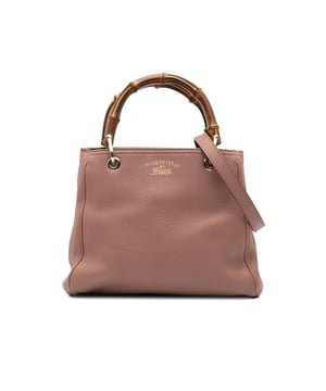The Bamboo Shopper features a leather body bamboo top handles a detachable and adjustable flat leather shoulder strap an open top with magnetic snap closure and interior zip and slip pockets.Brand: GucciCondition: Pre-lovedType: SatchelRating: B+Main Material: LeatherDimensions (LxWxD): 25x28x10Strap Drop: 50Handle Drop: 11Comments: Exterior Back Worn. Exterior Bottom Worn. Lock Scratched. Exterior Corners Worn. Embellishment Scratched. Exterior Front Worn. Exterior Front stained with Pen Mark. Exterior Handle Worn. Interior Pocket Worn. Interior Lining Worn. Practical Attachment Scratched. Exterior Side Worn. Exterior Top Worn. Zipper Scratched.