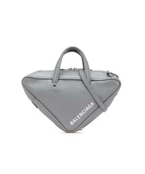 The Triangle Duffle bag features a leather body flat leather handles a detachable flat leather strap a top zip closure and an interior zip pocket.Brand: BalenciagaCondition: Pre-lovedType: SatchelRating: B+Main Material: LeatherDimensions (LxWxD): 15x35x8Strap Drop: 61Handle Drop: 9.5Comments: Exterior Back Worn. Exterior Bottom Out Of Shape Worn. Exterior Front Worn. Interior Pocket stained with Other. Interior Lining Scratched. Practical Attachment Scratched. Exterior Side Out Of Shape Worn. Exterior Top Out Of Shape Worn. Exterior Top stained with Other. Zipper Scratched.