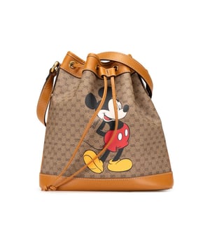 This bucket bag features a coated canvas body with leather trim an adjustable flat leather strap and a top drawstring closure.Brand: GucciCondition: Pre-lovedType: Bucket BagRating: B+Main Material: FabricDimensions (LxWxD): 26.5x24x11.5Strap Drop: 56Dust Bag: YesComments: Exterior Bottom Worn. Exterior Front Worn. Exterior Handle Creased Worn. Interior Lining Loose Stitching Worn. Practical Attachment Scratched. Exterior Top Worn.
