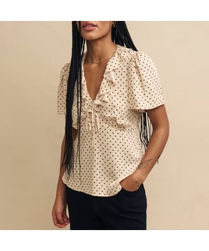 Women's Nobodys Child Joely Blouse. Every wardrobe needs a cute top like Joley. Woven entirely from responsible viscose, she’ll infuse a little vintage-inspired romance into your look with her fluted sleeves and floaty ruffles. We love the cream polka dot print and the figure-skimming fit. Style yours with black jeans.- V-neck.- Fluted sleeves.- Under bust seams designed to flatter.- String tie detail. Material: 100% Ecovero™ Viscose. Ref: T240662CRM.