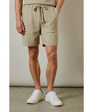 Distinctive seersucker texture adds visual interest and breathability to these casual shorts
        Comfortable elasticated waistband with adjustable drawstring for a personalised fit
        Relaxed leg shape offers ease of movement for all-day comfort
        Mid-thigh length provides a modern silhouette that works for various body types
        Cotton-rich fabric ensures these shorts remain soft and comfortable throughout the day
    
    These Burton seersucker shorts combine classic style with modern comfort, perfect for the man who appreciates timeless fashion. The textured fabric adds subtle sophistication while remaining thoroughly practical for warm-weather wear. Style them as shown with a matching polo shirt for a coordinated look that works brilliantly for weekend barbecues or casual pub gatherings with mates. Alternatively, pair with a crisp white t-shirt and trainers for an effortless daytime ensemble. The neutral tone makes these shorts incredibly versatile, allowing them to complement your existing wardrobe with ease. They're ideal for family gatherings, sporting events, or simply relaxing in the garden on sunny afternoons. Machine washable at 30 degrees, these shorts offer both style and practicality for the modern British man.