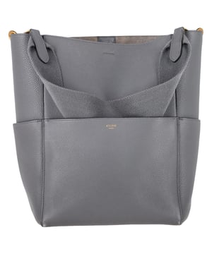 VINTAGE, RRP AS NEW
Elevate your everyday style with the Celine Sangle Tote Bag in luxurious grey calfskin leather, featuring a structured silhouette and minimal gold-tone hardware for timeless appeal. Its spacious interior and wide shoulder strap offer both comfort and function, perfect for daily errands or travel. **Styling Tip:** Pair it with a tailored blazer and neutral-toned trousers for an effortlessly chic, monochromatic look.

 Celine Sangle Tote Bag in Grey Calfskin Leather 

Condition: Very good
Signs of wear: Minor signs of wear, marks inside.
Packaging: Dust bag
Color: Grey
Material: Leather | calfskin leather
Size: One Size | One Size
Measurements: Width: 160; Height: 310; Length: 300; Handle drop: 0; Strap length: 0
SKU: NAPPUGBBA489580W