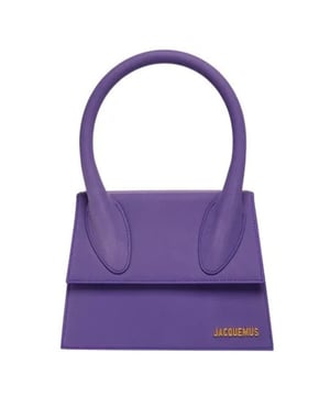 Elevate your accessory collection with the exquisite Jacquemus Le Grand Chiquito Purple Bag. This stunning designer piece combines luxurious craftsmanship with the perfect pop of vibrant purple, creating an unforgettable statement accessory. The compact yet practical size offers versatility for both day and evening wear, while the distinctive Jacquemus styling ensures you'll stand out from the crowd. A must-have investment piece that effortlessly transitions between seasons and complements any fashion-forward wardrobe. Dimensions: 18x13x7.5 cm. 100% Leather Made In Italy