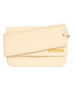 Elevate your accessory collection with the exquisite Jacquemus Le Carinu Ivory White Bag. This stunning designer piece combines timeless elegance with contemporary flair, making it the perfect statement accessory for any outfit. Crafted with meticulous attention to detail, this ivory white treasure embodies luxury and sophistication. The versatile design transitions effortlessly from day to evening, ensuring you'll stand out with refined style wherever you go. A must-have addition to any fashion-forward woman's wardrobe. Dimensions 12 x 18.5cm. 100% Leather Made In Spain