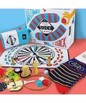The Sock Game Fathers Day Gift: The Sock Game is the ultimate family fun activity that will spice up your game nights! Perfect for kids and adults alike, this sensory game features a large, fluffy sock filled with thirty different items. Players spin the board to select an object, then race against time to find it in the sock. The first player to grab their object earns a point, making the game fast-paced and exciting!. What’s more, you can personalise your game experience by adding your own objects and writing them on the spinner’s blank spaces. This ensures that every game is unique and full of surprises! Whether you're playing in pairs or teams, this game encourages teamwork and a lot of laughter, creating memorable moments with your loved ones. As a special bonus, the game includes a pair of Father's Day gift socks from Mr. Heron, perfect for gifting or keeping for yourself! The Sock Game is guaranteed to bring joy, challenge, and excitement to any family gathering. Extra Product Details: - Fun family game for kids and adults - Includes a fluffy sock filled with 30 items - Customise with objects from your home - Can be played with 2 players or 2 teams - Comes with Father's Day gift socks from Mr. Heron - Ideal for game nights and family gatherings - Perfect gift for Father's Day or any occasion