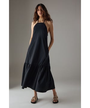 Crafted from breathable cotton poplin fabric for all-day comfort
        Delicate crochet trim detailing along the halterneck neckline adds a feminine touch
        Flattering drop waist silhouette with a relaxed midi length
        Elegant tiered hem creates movement and dimension
        Thin halter straps with back fastening for an adjustable fit
    
    This Warehouse sundress combines effortless style with practical comfort for warm-weather dressing. The relaxed drop waist silhouette creates a carefree aesthetic while the crochet trim adds a touch of artisanal detail to the halterneck design. Style with flat sandals and a woven tote for farmers' markets and weekend brunches, or dress up with espadrille wedges and statement earrings for garden parties. The versatile midi length works beautifully for coastal holidays - simply throw over your swimwear with a wide-brimmed hat for beach-to-bar ease. For cooler evenings, layer with a lightweight denim jacket and switch to ankle boots for an extended seasonal wardrobe staple that transitions seamlessly from day to night.