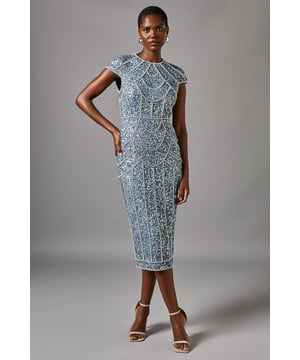 Exquisite hand-stitched embellishments adorn this elegant pencil dress
Sophisticated round neckline complements the cap sleeves
Curve-skimming silhouette flatters the feminine figure
Thigh-high slit adds a touch of allure to the refined design
Fully lined for a smooth, polished finish

Radiate sophistication at your next formal event in this stunning pencil dress from Coast. The intricate hand-stitched embellishments exude a luxurious aesthetic, while the sleek silhouette and thigh-high slit strike the perfect balance between elegance and allure. Pair it with understated jewellery and sleek heels for a refined, head-turning ensemble befitting of weddings, races, or any other special occasion.