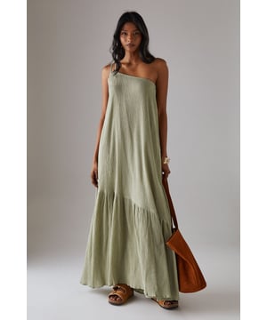 Asymmetric one-shoulder design with elegant double strap detail
        Lightweight cheesecloth fabric creates a breezy, effortless drape
        Flowing maxi length with feminine tiered hem detail
        Relaxed silhouette offers comfortable movement for all-day wear
        Versatile sundress that transitions seamlessly from day to evening occasions
    
    This striking Warehouse maxi sundress commands attention with its distinctive asymmetric neckline and double strap detail. The lightweight cheesecloth fabric creates a beautifully fluid silhouette that moves gracefully with every step, while the tiered hem adds a touch of feminine flair. For formal occasions, style with metallic strappy heels and statement gold jewellery as seen on our model - the chunky bangle creates a perfect contrast against the dress's soft texture. Alternatively, embrace a more relaxed daytime look with leather sandals and a woven clutch. The versatile design makes it an ideal choice for summer weddings, garden parties, or sophisticated evening events where you wish to project confidence with an edgy yet feminine aesthetic. The one-shoulder design offers a contemporary twist on classic occasion wear, ensuring you stand out for all the right reasons.
