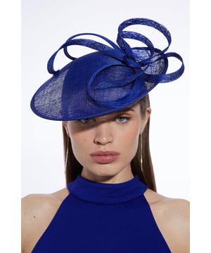 Get dressed up and finish the look with a fascinator, with an easy to wear small size and spiral detailing, fitted onto a comfortable headband. Styles perfectly with a dress or pantsuit in matching tones for a look ideal for wedding guest days and days at the racecourse. Spiral Detail Fascinator Smaller Size Statement Spiral Accent Easy to Wear Headband