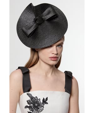Make a captivating entrance with this Karen Millen disk bow detailed fascinator, designed to transform any formal ensemble into something truly remarkable. The distinctive angled silhouette sits against the hair, while the prominent bow detail adds a touch of feminine charm to the structured design. Style with an elegant updo or sleek straight hair to showcase the fascinator's architectural form. Perfect for weddings, race days and garden parties, this head-turning accessory pairs wonderfully with tailored dresses or sophisticated jumpsuits. For maximum impact, complement with minimal jewellery to keep all attention on this striking headpiece. The secure headband ensures comfort throughout your special occasion, allowing you to celebrate in style without constant adjustments.  Striking disk-shaped fascinator with bow detail Angled silhouette creates a dramatic profile Secure headband Textured woven finish Statement size perfect for formal occasions and race days