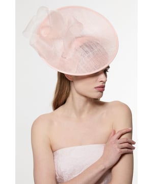 Make a captivating entrance with this Karen Millen asymmetric fascinator, designed to turn heads at your next special occasion. The architectural silhouette features a gracefully curved disk base adorned with flowing mesh detailing that creates movement and drama. Style with a tailored dress or jumpsuit in a complementary tone for race day sophistication, or pair with an elegant evening ensemble for wedding celebrations. The fascinator works with sleek, pulled-back hair to showcase its artistic structure, though it equally complements soft waves for a more romantic aesthetic. This versatile headpiece transitions effortlessly from daytime formal events to evening soires, adding that perfect finishing touch to your carefully curated outfit.  Striking asymmetric design with disk detailing Delicate mesh overlay Sculptural wave effect Secure headband fitting for comfortable all-day wear Versatile statement piece that complements both updo and loose hairstyles