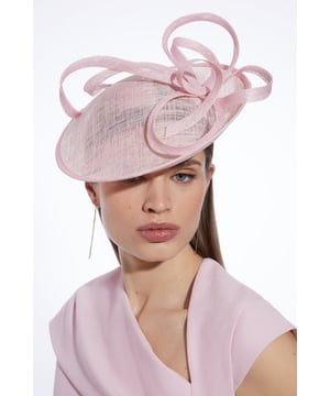 Get dressed up and finish the look with a fascinator, with an easy to wear small size and spiral detailing, fitted onto a comfortable headband. Styles perfectly with a dress or pantsuit in matching tones for a look ideal for wedding guest days and days at the racecourse. Spiral Detail Fascinator Smaller Size Statement Spiral Accent Easy to Wear Headband