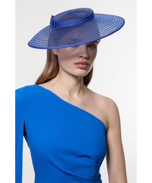 This Karen Millen fascinator transforms any ensemble into a statement look with its distinctive asymmetric silhouette and refined disk bow detail. The structured wide brim creates a dramatic profile that frames the face beautifully, whilst the semi-transparent layered construction adds a contemporary touch to this classic accessory. For wedding guest attire, complement with a sleek updo and a fitted dress in a complementary tone. The versatile design transitions effortlessly from daytime garden parties to more formal evening occasions, making it an invaluable addition to your special event wardrobe.  Striking asymmetric design with disk bow detail Semi-transparent layered construction Wide-brimmed structure Secure fit design