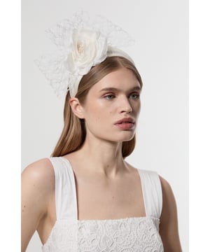 Make a statement at your next special event with this exquisite Karen Millen fascinator. The elegant rose-shaped centrepiece is complemented by flowing veil netting that adds drama and sophistication to your ensemble. Perfect for race day attire, this headpiece pairs wonderfully with a tailored dress or coordinated two-piece. For wedding guest styling, match with a structured midi dress and pointed court shoes for a refined look. The secure headband ensures your fascinator stays perfectly positioned throughout celebrations, whilst the intricate netting detail frames your face with a touch of vintage-inspired glamour. This versatile accessory transitions effortlessly from daytime ceremonies to evening receptions, adding that perfect finishing touch to your carefully curated outfit.  Striking rose-shaped centrepiece adorned with delicate veil netting Secure headband design Dramatic mesh veil detail Versatile fascinator suitable for races, weddings and formal occasions