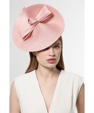 Make a captivating entrance with this Karen Millen disk bow detailed fascinator, designed to transform any formal ensemble into something truly remarkable. The distinctive angled silhouette sits against the hair, while the prominent bow detail adds a touch of feminine charm to the structured design. Style with an elegant updo or sleek straight hair to showcase the fascinator's architectural form. Perfect for weddings, race days and garden parties, this head-turning accessory pairs wonderfully with tailored dresses or sophisticated jumpsuits. For maximum impact, complement with minimal jewellery to keep all attention on this striking headpiece. The secure headband ensures comfort throughout your special occasion, allowing you to celebrate in style without constant adjustments.  Striking disk-shaped fascinator with bow detail Angled silhouette creates a dramatic profile Secure headband Textured woven finish Statement size perfect for formal occasions and race days