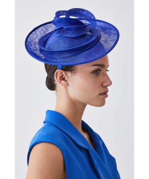 Get dressed up and finish the look with a fascinator, with an easy to wear small size and spiral detailing, fitted onto a comfortable headband. Styles perfectly with a dress or pantsuit in matching tones for a look ideal for wedding guest days and days at the racecourse. Asymmetric Disc Headband Fascinator Unique, Swirling Design Sheer, Circular Disc Base Easy to Wear, Smaller Size Comfortable HeadbandBrowse this seasons women's fascinators or discover the full range of women's accessories now.