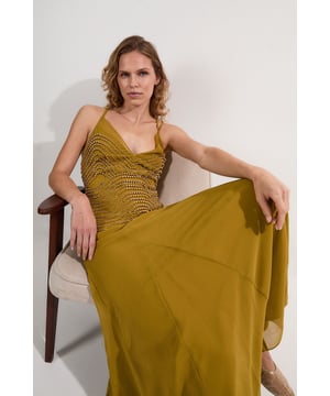 Make a statement at your next special event with this show-stopping Karen Millen maxi dress. The intricate geometric beading adorning the bodice catches the light with every movement, whilst the plunging neckline and striking cross-back detail add a contemporary touch to this timeless silhouette. The flowing woven fabric creates an ethereal quality as you move, making it ideal for summer weddings, gala dinners or evening receptions. Style with minimalist strappy heels and a sleek clutch to let the dress command attention. For cooler evenings, drape a lightweight pashmina over your shoulders. This versatile piece transitions effortlessly from formal ceremonies to evening celebrations, ensuring you remain the epitome of sophistication throughout any occasion.  Striking geometric beaded embellishment across the bodice Elegant plunge neckline frames the dcolletage Delicate strappy design with sophisticated cross-back detail Flowing woven maxi silhouette Floor-length cut