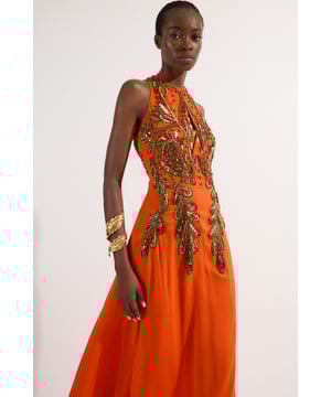 Make a statement at your next formal event with this show-stopping Karen Millen maxi dress. The halterneck design frames the dcolletage whilst the intricate bugle bead embellishment creates a focal point that demands attention. The flowing woven fabric cascades elegantly to the floor, creating a graceful silhouette. Style with metallic strappy sandals and a compact clutch for weddings or black-tie events. Complete your ensemble with delicate gold-toned jewellery to complement the dress's ornate detailing without overwhelming its impact. This piece transitions effortlessly from daytime celebrations to evening soires with just a change of accessories.   Halterneck design with intricate bugle bead embellishment across the bodice Flowing woven maxi silhouette Striking geometric pattern detailing Sleeveless cut with a high neckline Floor-length style with subtle train effect at the back