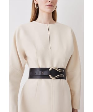 Equestrian influences define this cinching waist belt, shaped with a Obi-inspired wide fit and featuring a slim tab that threads through the oversized horseshoe-style buckle. Layer this accessory over your edit of blazers, jersey tank tops, and flowing dresses for an elevated finish to every ensemble.Wide fitPolished buckleAdjustable lengthBrowse this seasons women's belts or discover the full range of women's accessories now.