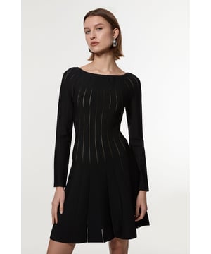 This Karen Millen knitted dress combines timeless elegance with contemporary design through its sophisticated pointelle stitch detailing. The fit and flare silhouette creates a naturally feminine shape that works wonderfully for daytime occasions. Style with statement earrings as shown for casual family gatherings, or pair with a structured crossbody bag and ballet flats for weekend brunches. For cooler days, layer with a cropped denim jacket and ankle boots for an effortlessly chic ensemble. The versatile boat neckline allows for various jewellery options; try a delicate pendant necklace to complement without overwhelming. This dress transitions seamlessly from office to evening drinks when accessorised thoughtfully, making it a wardrobe staple that offers countless styling possibilities throughout the seasons.  Elegant boat neckline frames the decolletage beautifully Distinctive pointelle stitch detailing creates visual interest throughout Flattering fit and flare silhouette accentuates the waistline Long sleeves offer versatility for transitional weather Soft knitted fabric provides comfort whilst maintaining structure