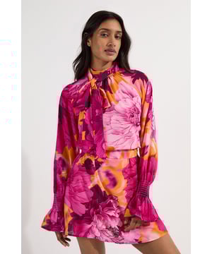This Karen Millen woven mini dress combines eye-catching floral patterns with a feminine silhouette that's perfect for daytime occasions. The elegant tie neck detail and billowing sleeves create a romantic aesthetic that's both contemporary and timeless. Style with white trainers and a crossbody bag for casual weekend brunches, or dress up with block-heeled ankle boots and a leather jacket for dinner with friends. The elasticated waist and cuffs ensure comfort whilst maintaining a flattering shape. This versatile piece transitions effortlessly from family gatherings to casual office days when paired with a tailored blazer and ballet flats. The mini length makes it ideal for the warmer months, but can be styled with tights and chunky boots when temperatures drop.  Elegant tie neck detail creates a sophisticated high neckline Striking floral print woven fabric with vibrant contrast tones Billowing long sleeves with elasticated cuffs for a romantic silhouette Mini length design perfect for showcasing your legs Flattering elasticated waist detail with gentle gathering for added movement
